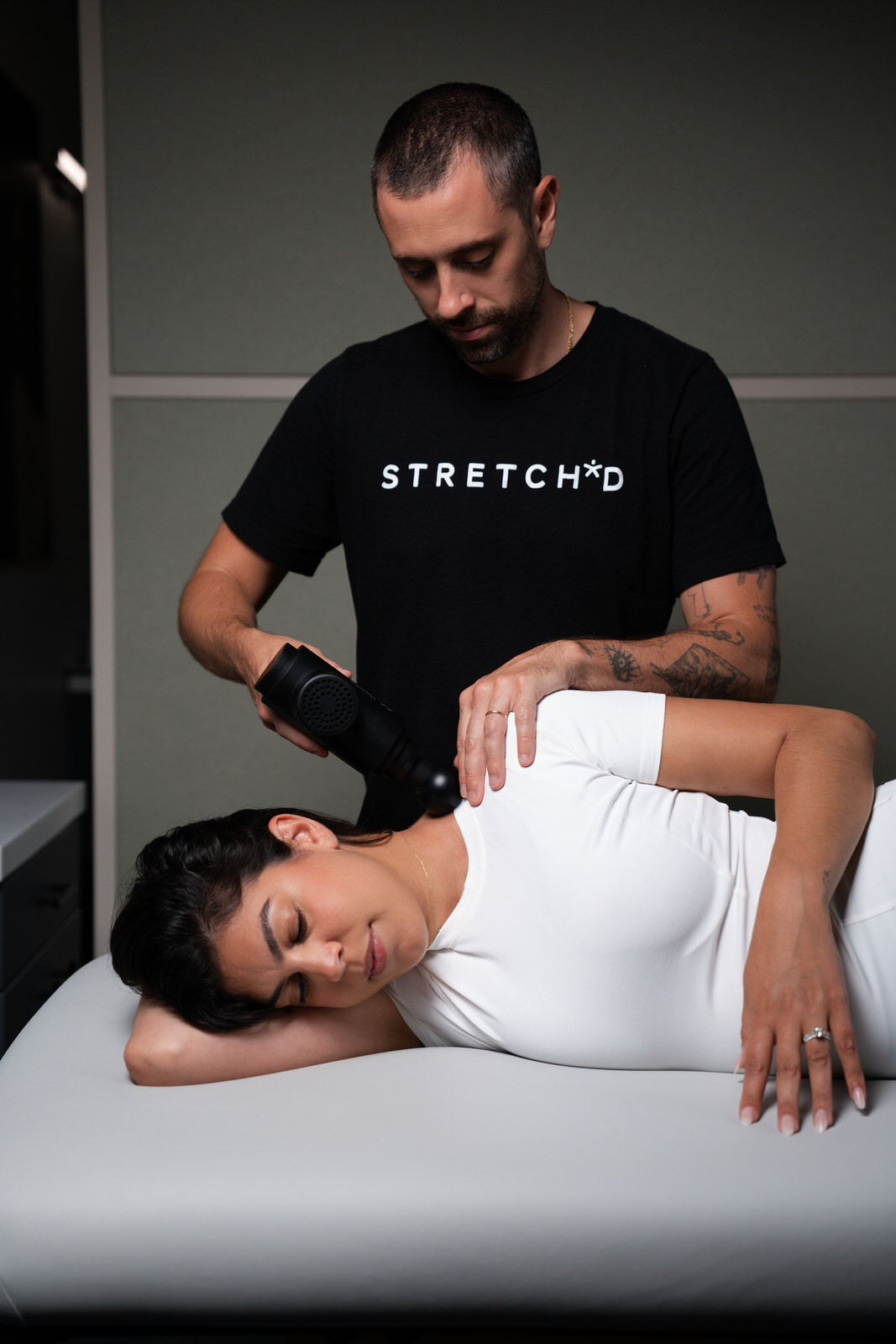 Stretch*d session — woman receiving stretch therapy